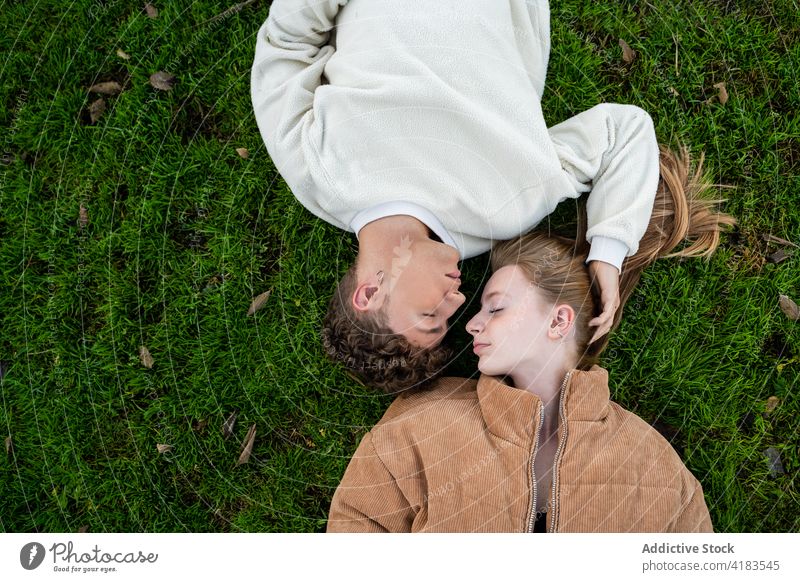 Couple lying on meadow and closed eyes couple relax lawn relationship love gentle spend time summer idyllic rest spare time bright aroma tender natural