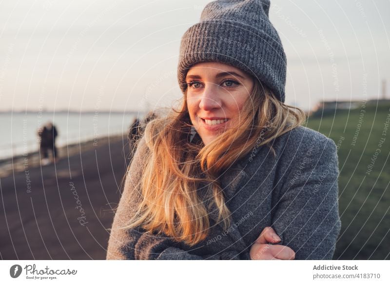 Happy woman in warm knitted wear portrait nature autumn cheerful happy traveler enjoy sunny rest young female lifestyle relax smile trendy positive chill glad