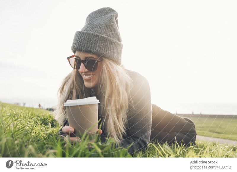 Woman drinking coffee near sea woman seaside rest traveler takeaway autumn relax young female lifestyle beverage enjoy nature to go vacation cup tourism