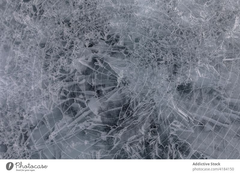 Abstract pattern of frozen lake in winter ice texture crack abstract background water chaotic surface natural frost effect baikal siberia russian federation
