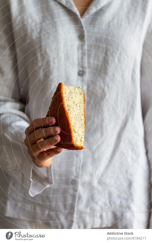 Unrecognizable woman with piece of cake breakfast sponge homemade dessert food female morning yummy tasty pastry meal sweet treat delicious delectable baked