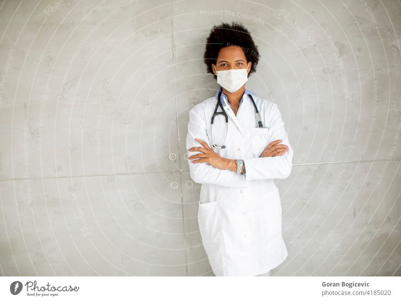 Female African American doctor wear white uniform and protective facial mask adult african american black clinic concept corona coronavirus covid epidemic face