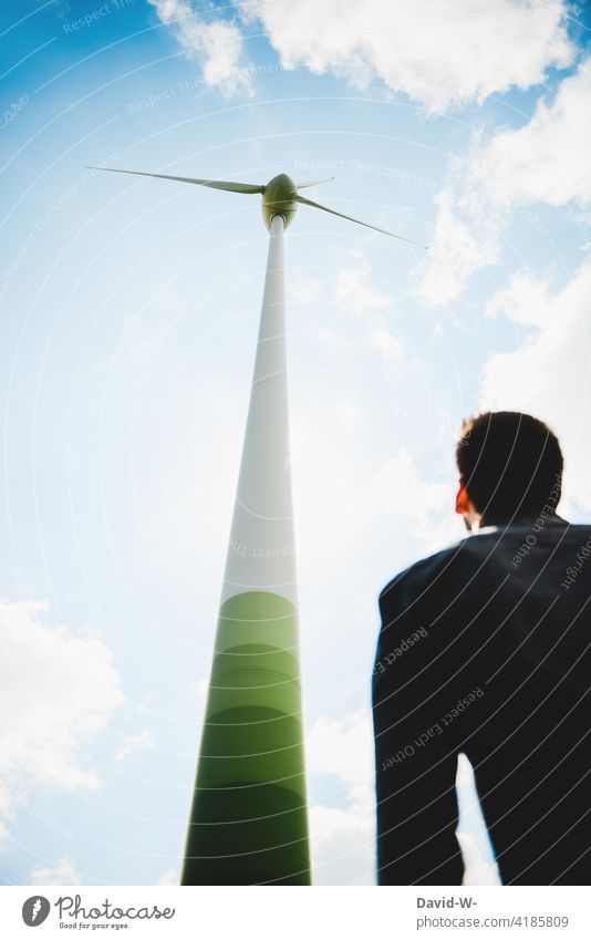 Wind energy - man looking at wind turbine wind power Pinwheel Energy industry Renewable energy Resource Eco-friendly Sky Wind energy plant