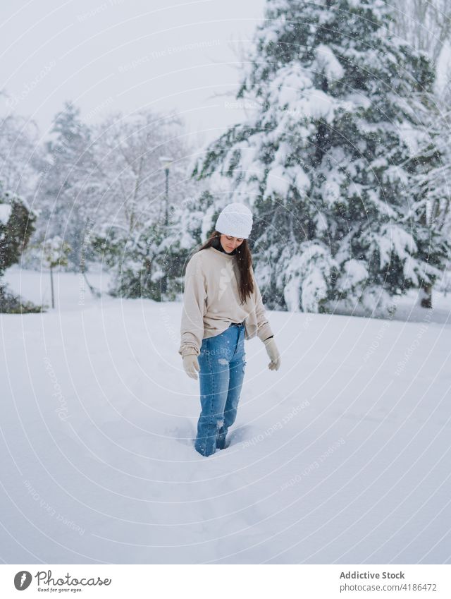 Woman on snowy park in winter city woman road sky cold weather spain madrid alone vegetate tree building trace jeans wintertime town female mount lonely white