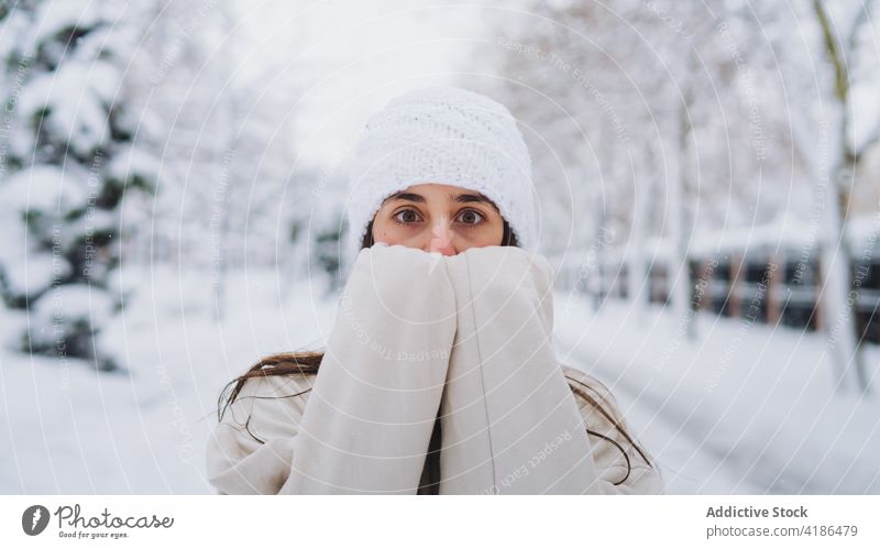 Unrecognizable astonished woman covering face in winter city cover face amazed surpised fear snow town portrait cold weather hide scare omg park vegetate spain