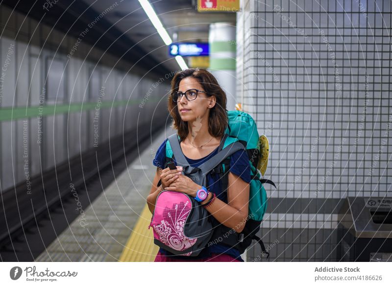Young caucasian woman waits for train in subway station 30s young Japan travel