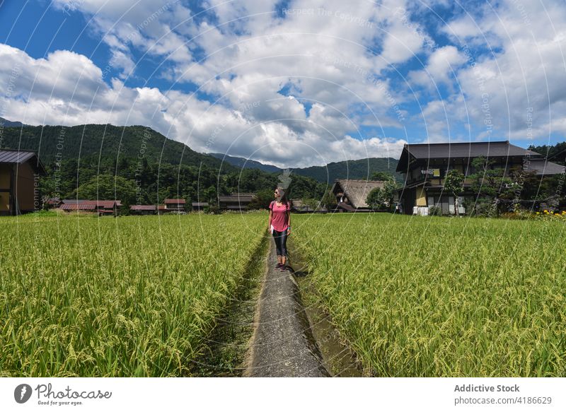 Young female traveler in Shirakawago historical Japanese village 30s young caucasian woman field