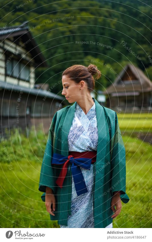 Exterior portrait of female caucasian traveler in traditional Japanese kimono 30s young woman exterior