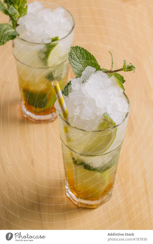 Mojito cocktail with lime and mint in glasses mojito alcohol drink ice beverage cold refreshment squeezer citrus tasty summer fruit aperitif liquid delicious