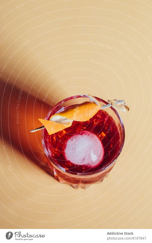 Glass of refreshing classic Negroni cocktail on light surface negroni alcohol bitter orange refreshment blend cold citrus delicious mix drink booze beverage gin