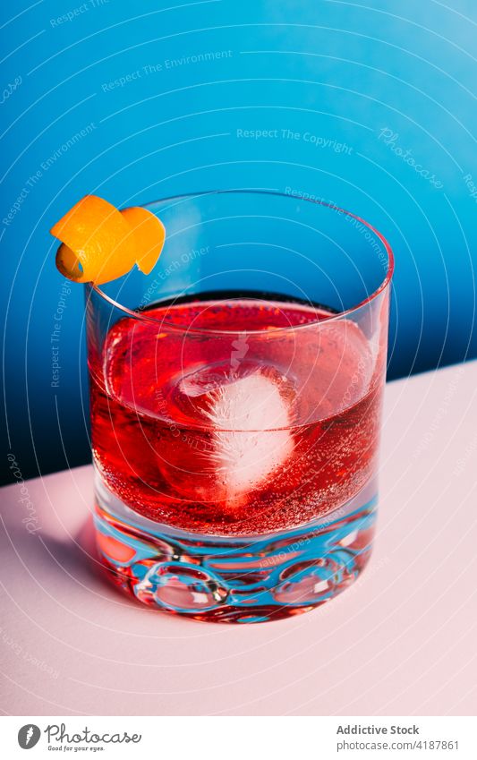 Glass of refreshing classic Negroni cocktail on light surface negroni alcohol bitter orange refreshment blend cold citrus delicious mix drink booze beverage gin