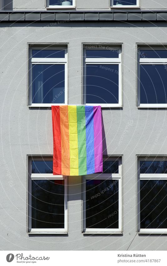 rainbow flag on grey facade Rainbow flag symbol LGBT gay lesbian awakening change Peace Tolerant Acceptance lesbians Transgender queer homosexual Pride