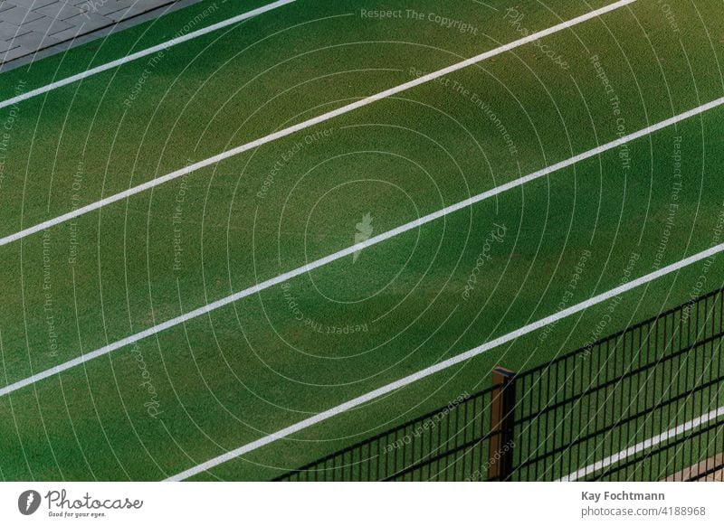white lines on green race course arena athletics background colorful compete competition dedication distance empty exercise field grass lane new path pattern