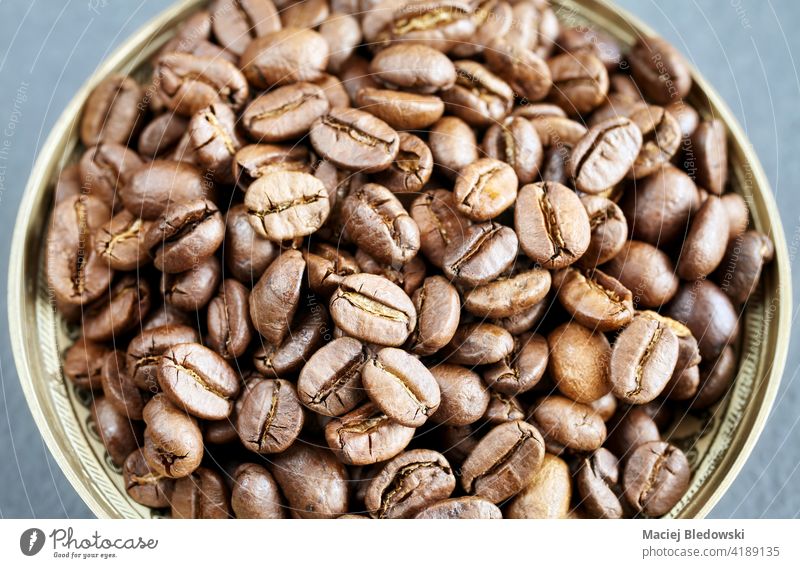 Roasted coffee beans in a bowl, selective focus. roasted caffeine drink brown food organic healthy energy close up