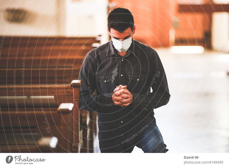 Man with mouth guard / mask in church Church corona Mask Respirator mask pray Kneel Prayer Hope Belief Fears Fear of the future Distress fears of existence
