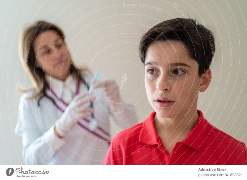 Doctor making injection for scared boy child vaccine coronavirus syringe doctor pain hurt covid 19 kid covid19 pandemic treat infection medical prevent