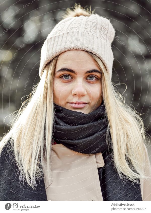 Charming woman in outerwear on sunny day sincere feminine gentle tender charming friendly pleasant portrait knitted hat scarf warm clothes style calm cold