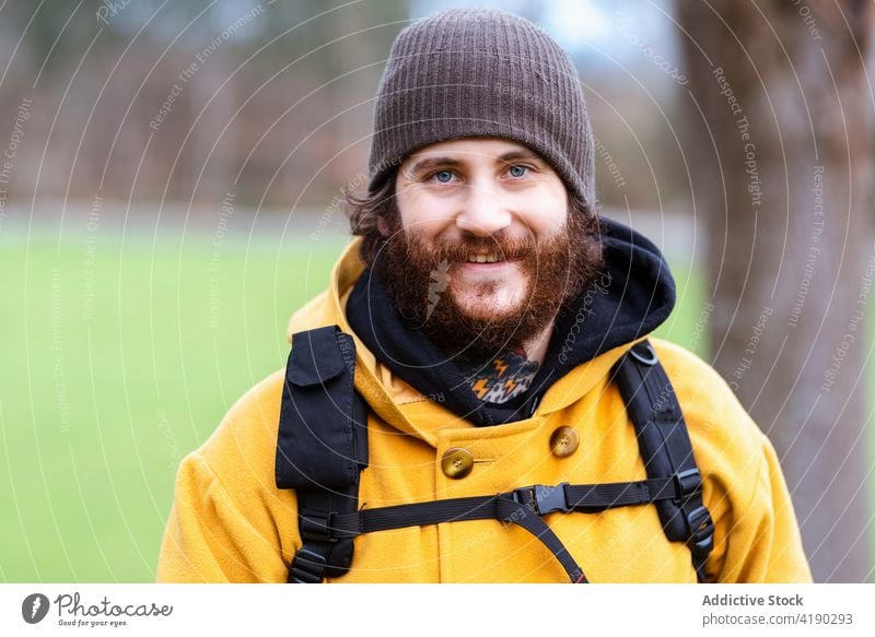 Tourist standing on nature and looking at camera traveler wanderlust hipster portrait man trip backpack backpacker trekker beard male outerwear tourism vacation