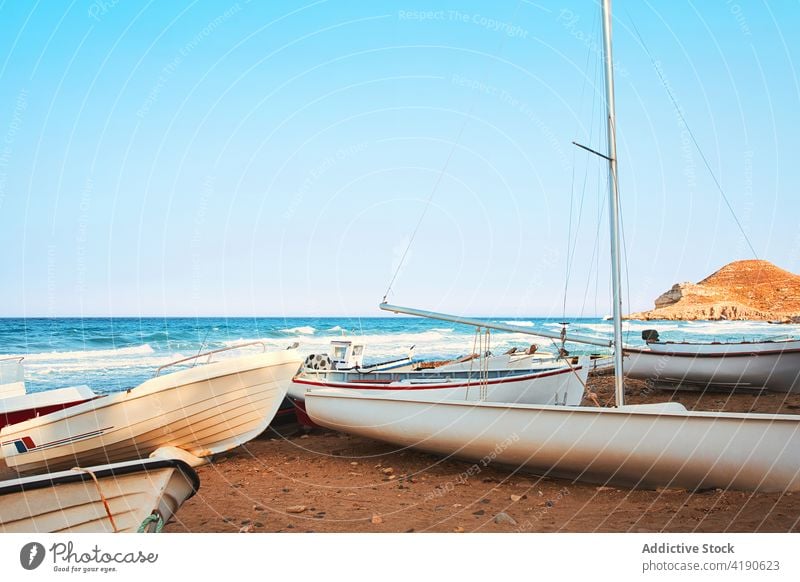 Fishing boats on the beach at sunset andalusian ocean fishing boat blue turquoise vessel ship sunrise mediterranean sea vacation water waves cabo de gata