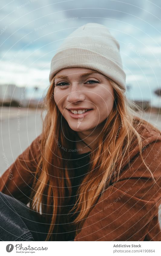 Happy lady looking at camera on street woman confident style appearance personality tranquil street style city fashion young long hair ginger hair trendy cool
