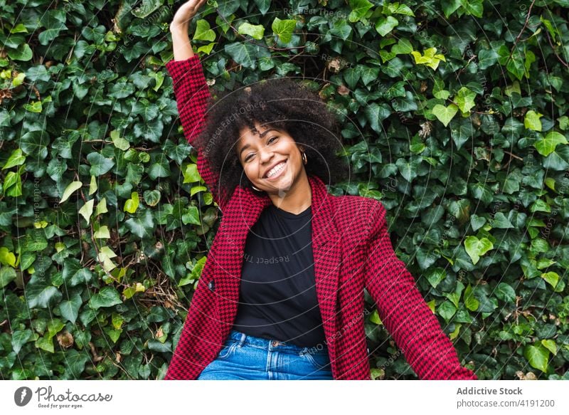 Carefree ethnic woman in park looking at camera carefree enjoy weekend freedom delight summer afro hairstyle female black african american happy smile