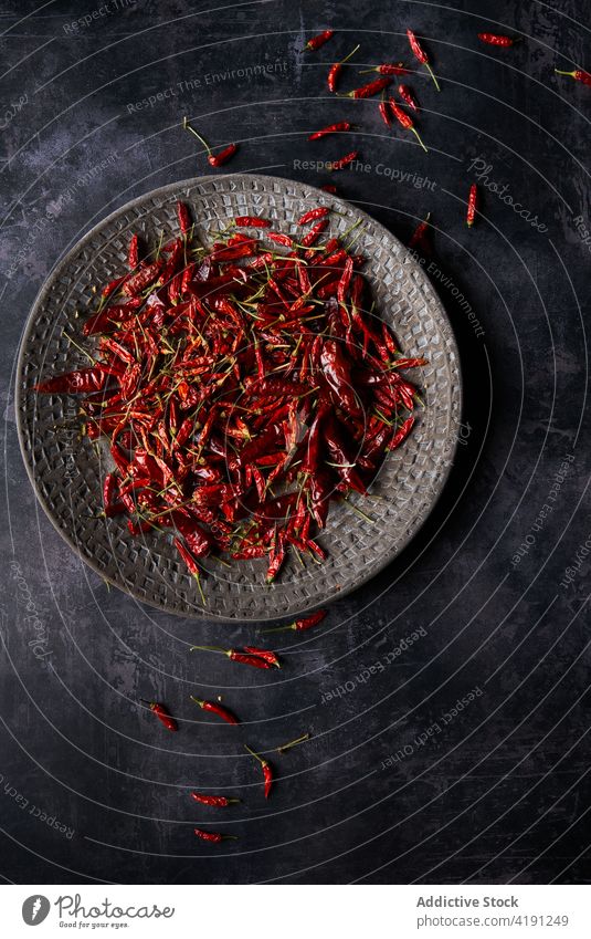 Heap of dried chili peppers on plate placed on table vegetable hot pile gourmet ingredient spicy food spice heap delicious flavoring kitchen culinary healthy