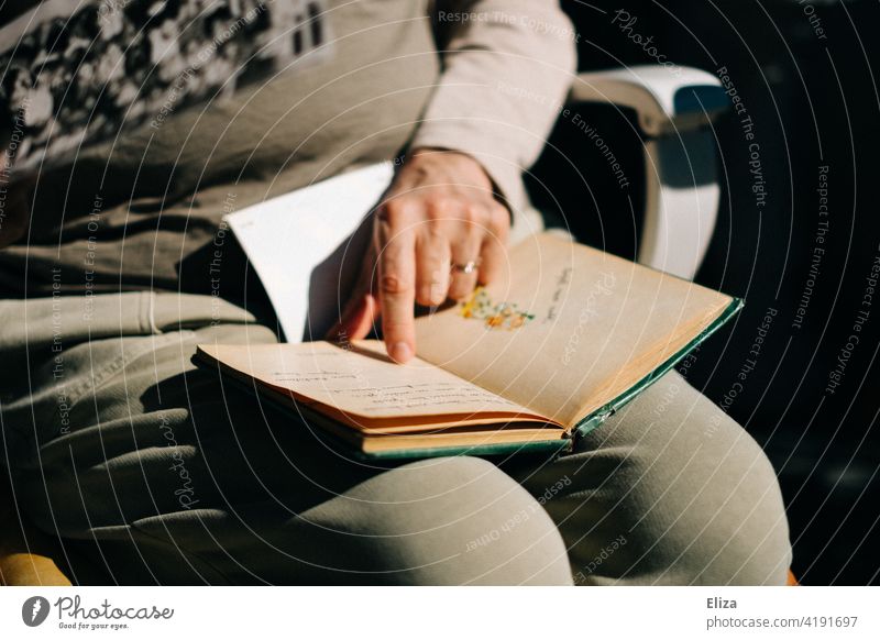 A woman leafs through an old poetry album or diary remembrances Friendship book Diary Friendship album Woman To leaf (through a book) Book Old Page