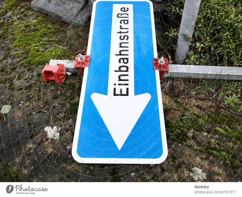 Blue traffic sign with the inscription one-way street lying on the ground at a construction site in Oerlinghausen near Bielefeld at the Hermannsweg in the Teutoburg Forest in East Westphalia-Lippe