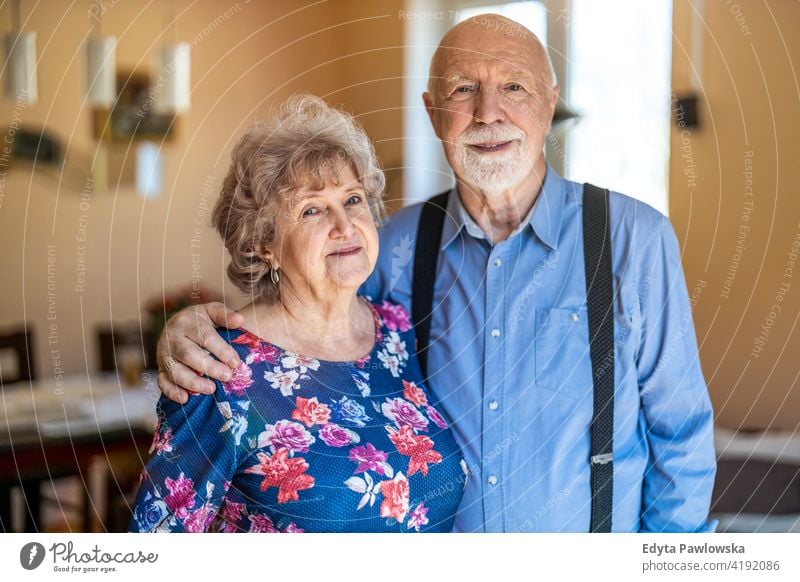 Happy senior couple together at home real people candid genuine woman mature female love bonding Caucasian elderly house old aging domestic life grandmother