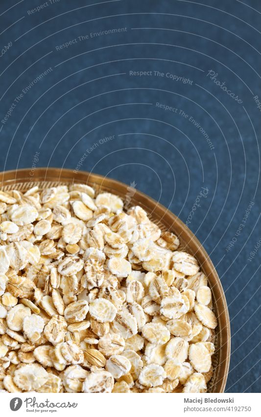 Close up picture of barley flakes in a bowl, selective focus. food dry natural raw breakfast fiber healthy cereal ingredient diet organic whole vegan