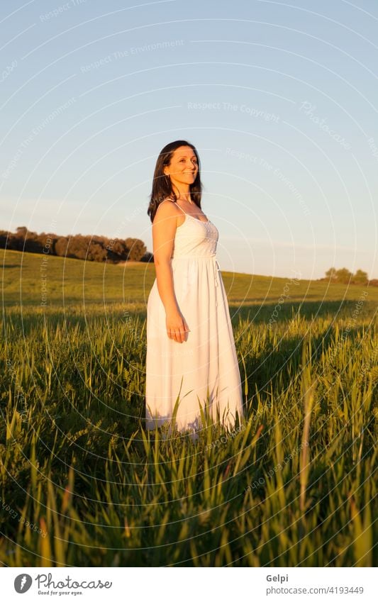 Woman looking at side relaxing on a meadow girl park beautiful spring pensive think thought sun sunny summer sunlight nature outdoor person female face woman