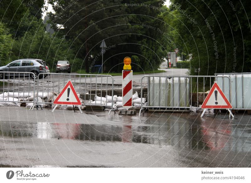 A flooded road was closed due to high water after heavy rainfall downpour Thunder and lightning Flood Climate Climate change Warning sign blocking Bark