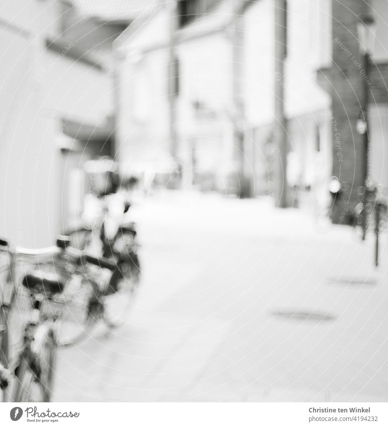 Empty pedestrian zone in the city center with parked bicycles. Black and white and blurred. downtown Pedestrian precinct Deserted Building Shops Architecture