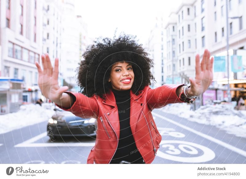Cheerful black showing frame gesture on city street woman glad demonstrate style optimist individuality cool delight female glee toothy smile sincere afro