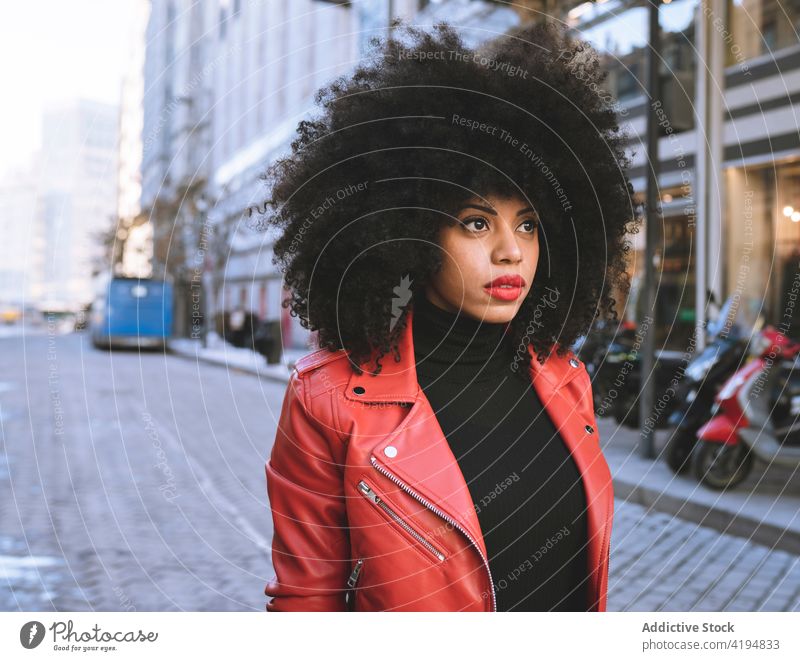 Black woman with afro hair on the street african american black style city urban optimist individuality curly hair cool delight female sincere carefree joy show