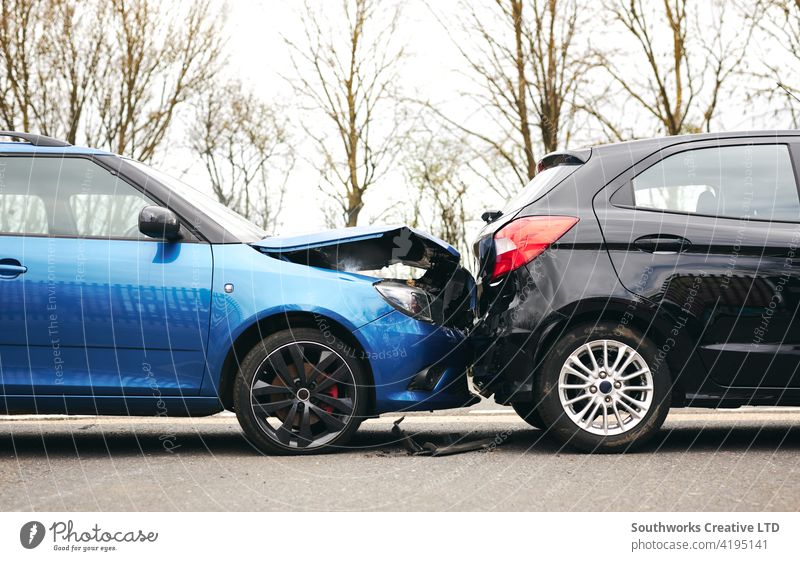 Two Damaged Cars Involved In Road Traffic Accident Showing Smoke After Collision car accident wreck crash loss adjuster insurance claim auto damage collision