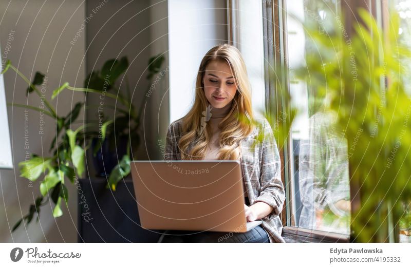 Young businesswoman using laptop in her office girl people Entrepreneur successful professional young adult female lifestyle indoors millennial attractive