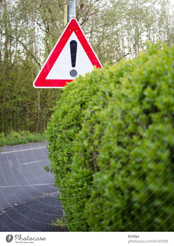 General danger spot, traffic sign 101 behind a hedge Road sign Traffic sign 101 Warn Warning sign Road traffic Caution Street Signs and labeling