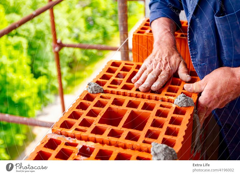Worker is building wall with red blocks and mortar Accuracy Accurate Activity Architecture Block Brick Bricklayer Bricklaying Brickwork Builder Building Site