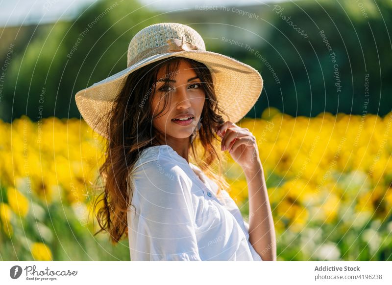Young woman in sunflower field in summer carefree yellow bloom enjoy female happy stand nature positive meadow countryside young optimist natural idyllic