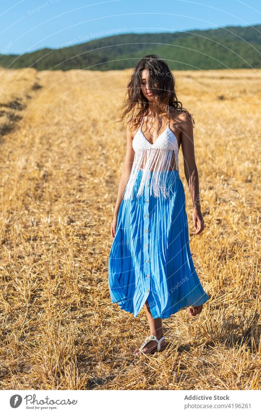 Carefree woman in field in summer dry countryside carefree serene slim grace sunny female harmony peaceful tassel meadow nature idyllic style dried bra skirt