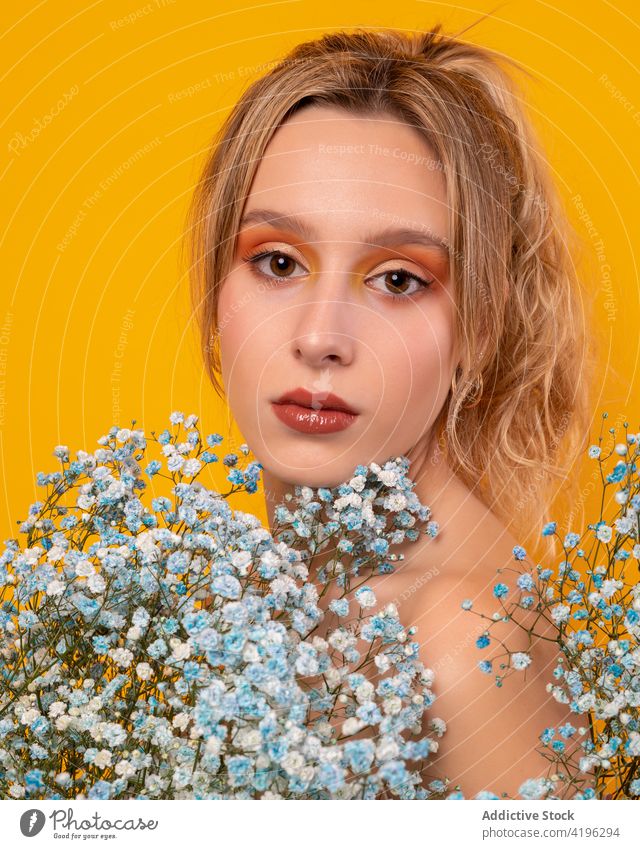 Beautiful woman with blue gypsophila flowers in studio style tender charming blossom bare shoulders gorgeous sensitive beautiful young attractive pretty flora