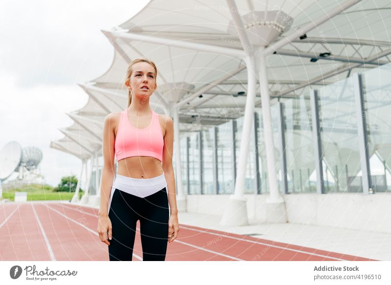 Blonde sportswoman resting on the track blonde city run running exercise lifestyle healthy attractive sportswear preparation athlete female caucasian fit