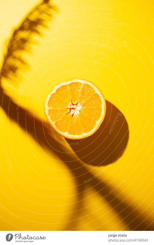 A slice of orange isolated on yellow background juicy food fruit fresh health close-up vitamin organic natural color image tropical healthy eating diet snack