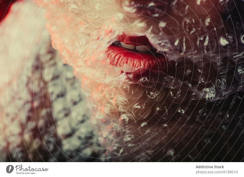 Sensual woman with red lips in studio bubble wrap sensual fashion style enigma mystery seductive female model dark feminine vogue neon light temptation