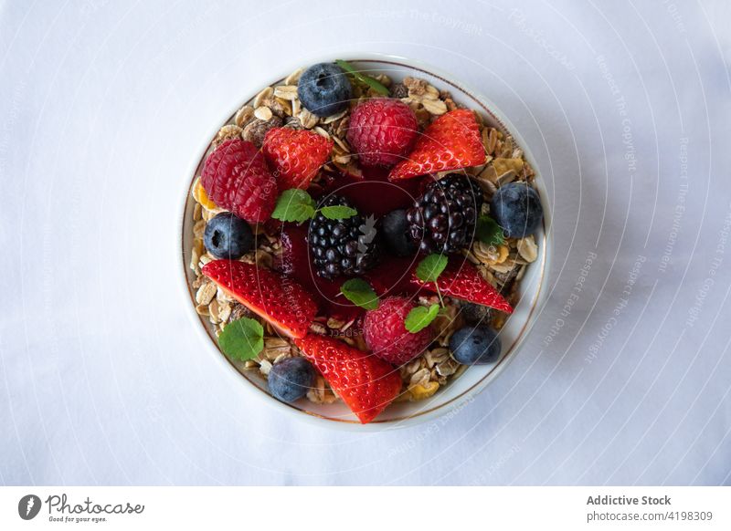 Delicious breakfast with muesli and berries in bowl berry granola super food healthy vitamin meal fresh mint morning sauce healthy food appetizing various