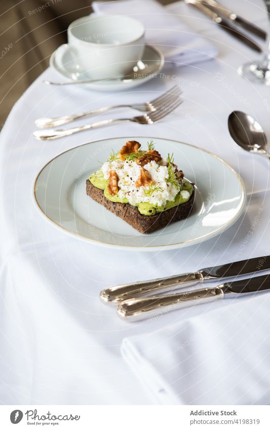 Delicious avocado and ricotta toast served on plate walnut breakfast healthy delicious food meal tasty nutrition morning cafe table dish yummy gourmet portion