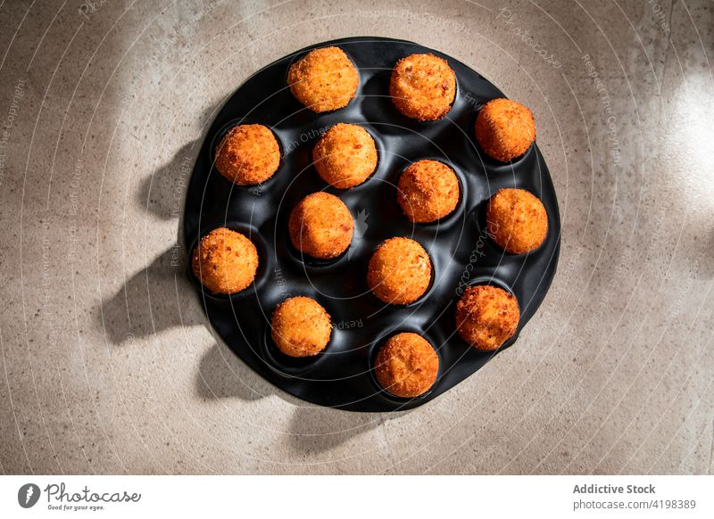 Deep fried cheese balls on concrete table deep fried cook dry ice cutting board culinary restaurant crust crispy tasty food steam kitchen yummy appetizing