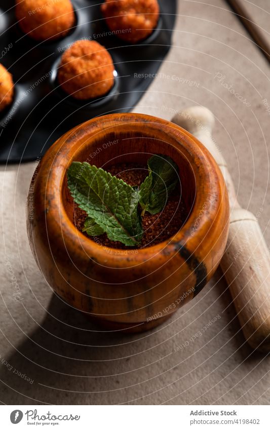 Mortar with ground red pepper and mint leave with pestle mortar powder leaf ground pepper seasoning spice condiment tool cheese ball fried dust instrument cook