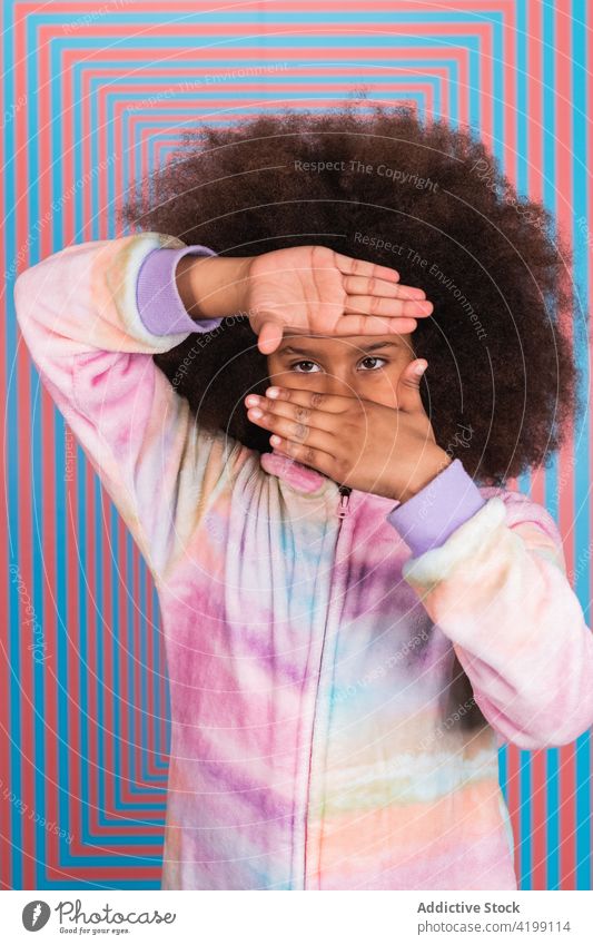 Black girl showing framing gesture in studio frame hand symbol sign photo imagination fantasy teenage ethnic black african american rectangular tunnel style